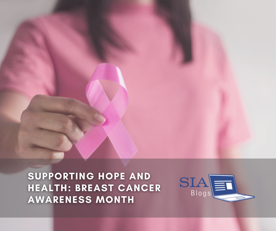 A person wearing a pink shirt holds a pink ribbon, symbolizing support for breast cancer awareness. The caption reads, "Supporting Hope and Health: Breast Cancer Awareness Month," with the SIA Blogs logo.