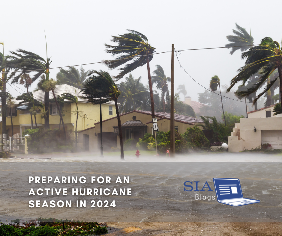 A coastal neighborhood is battered by strong winds and heavy rain, with palm trees bending and streets flooded. The caption reads, "Preparing for an Active Hurricane Season in 2024," along with the SIA Blogs logo.