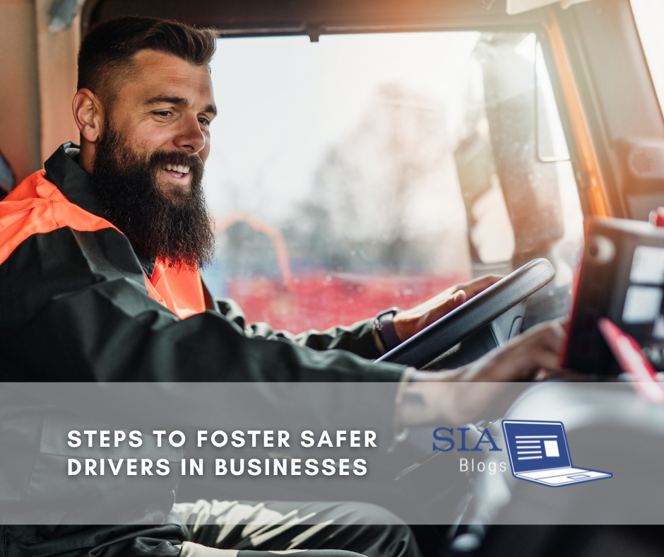 A bearded man in a safety vest smiles while driving a large vehicle, focusing on the road ahead. The caption reads, "Steps to Foster Safer Drivers in Businesses," along with the SIA Blogs logo.