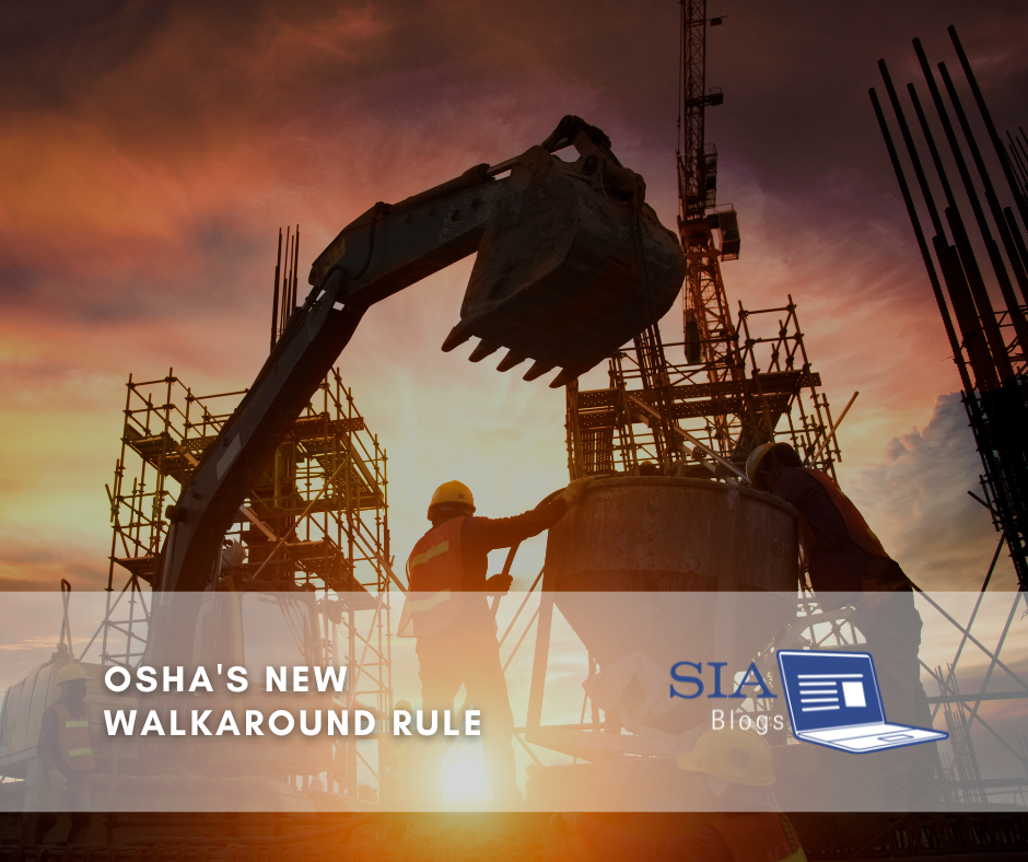 Construction workers are silhouetted against a dramatic sunset as they operate heavy machinery and work on scaffolding at a building site. The caption reads, "OSHA's New Walkaround Rule," along with the SIA Blogs logo.
