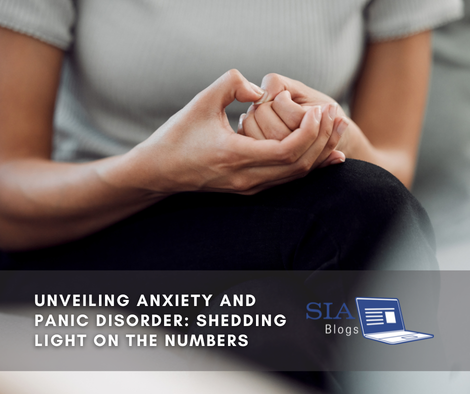 A person sits with hands clasped together, fingers nervously intertwined, conveying a moment of anxiety or contemplation. The caption reads, "Unveiling Anxiety and Panic Disorder: Shedding Light on the Numbers," with the SIA Blogs logo.