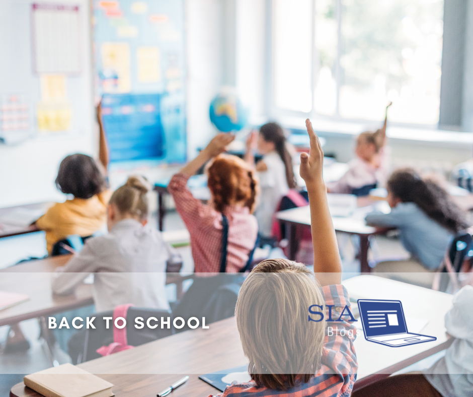 A classroom filled with young students, many raising their hands, is seen in a bright, engaging learning environment. The caption reads, "Back to School," alongside the SIA Blogs logo.