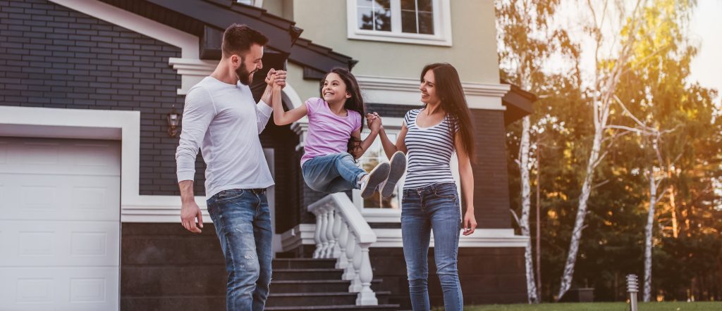 Family in from of house representing Homeowners Insurance