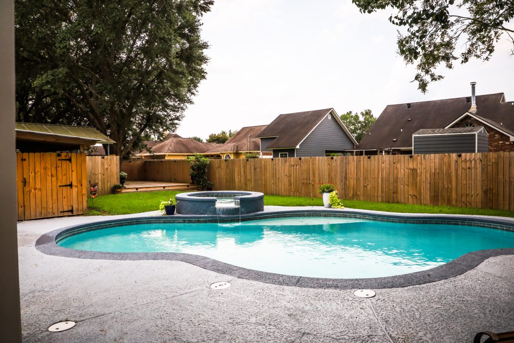 Backyard swimming pool with fence at a residential home showing pool liability insurance considerations for homeowners in North Carolina