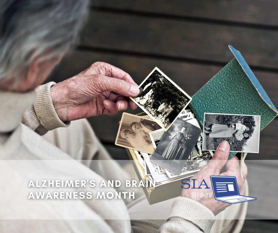An elderly person gently holds a box of old black-and-white photographs, reminiscing over memories of the past. The caption reads, "Alzheimer's and Brain Awareness Month," with the SIA Blogs logo.