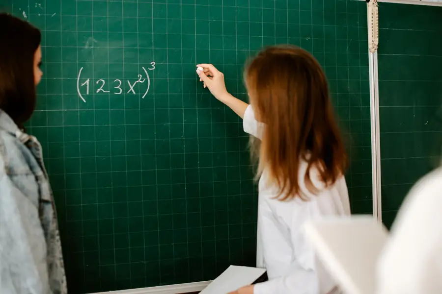 Teacher writing on board