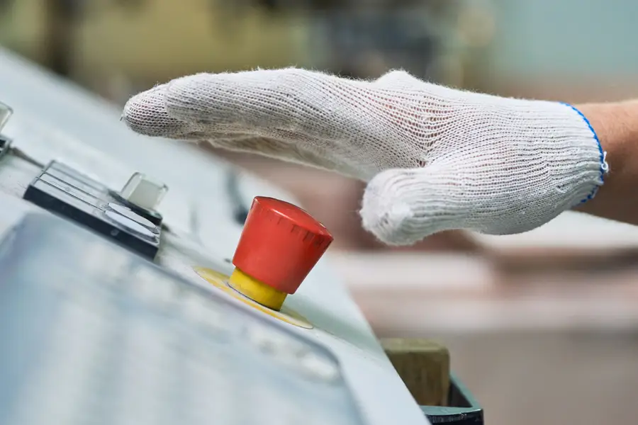 Close up of hand pressing red button