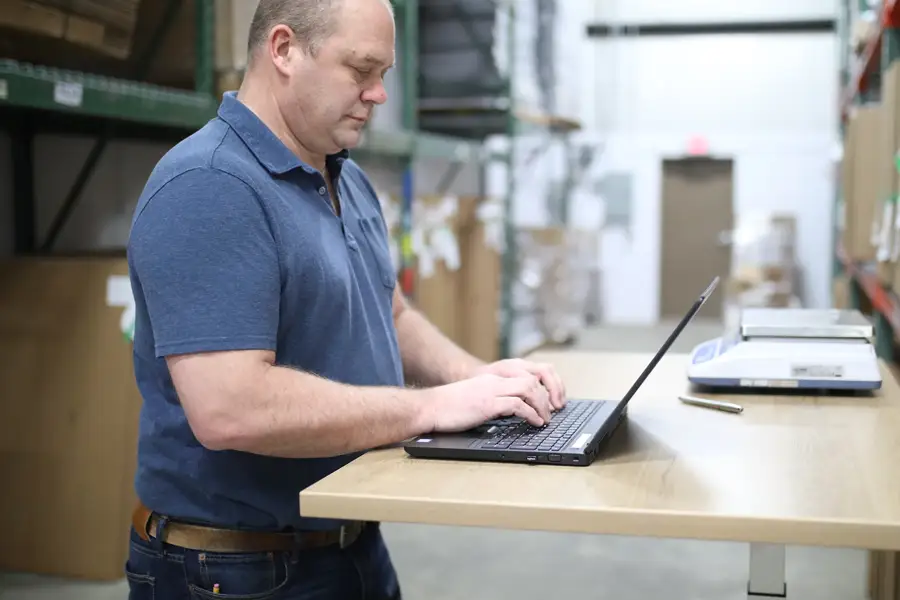 Warehouse worker using laptop