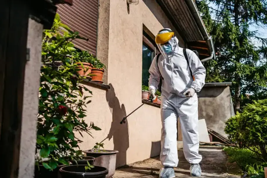 Pesticide handler spraying outside home
