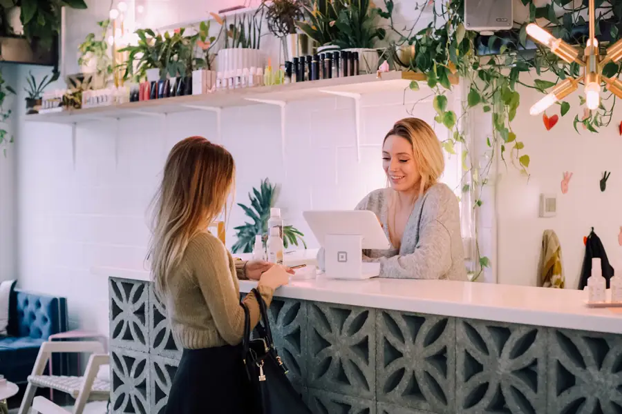 Woman purchasing item at retail store